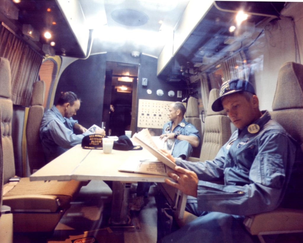 Apollo 11 astronauts (left to right) Michael Collins, Edwin Aldrin Jr., and Neil Armstrong relax in the Mobile Quarantine Facility as part of planetary protection measures.