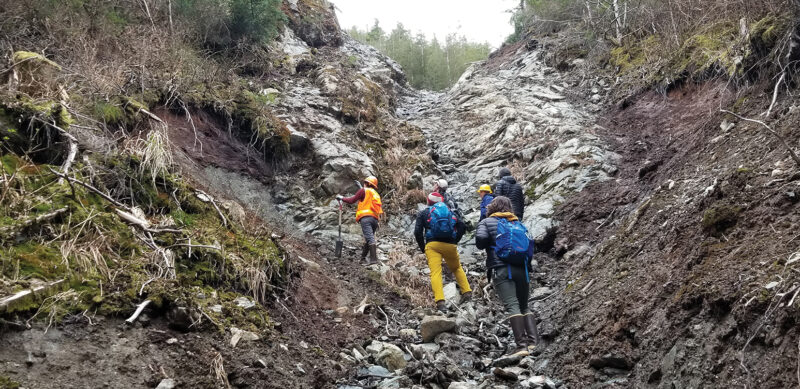 Sitka Sound Science Center employees assess a landslide.