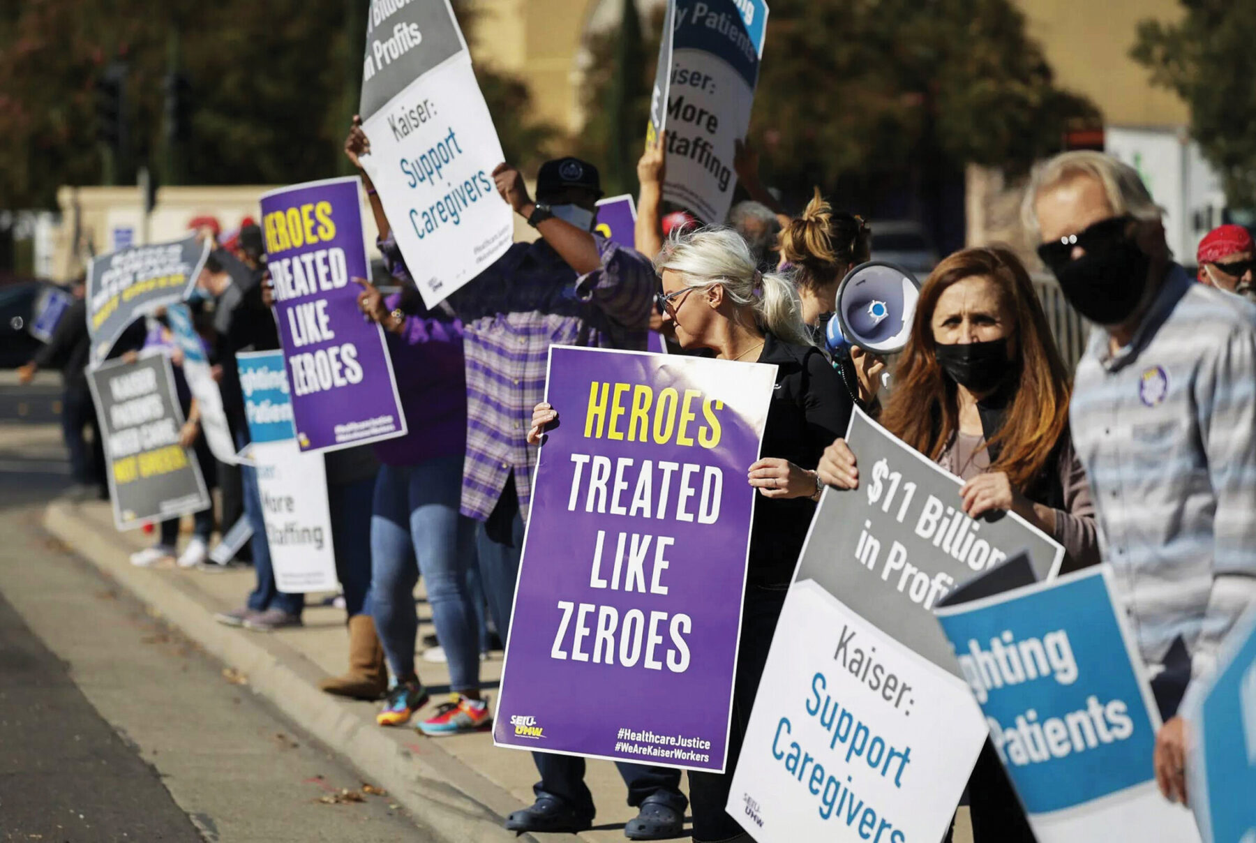 Hospital staffers and union organizers waved signs and banners in protest over staffing shortages at Kaiser Permanente Hospital in Roseville on October 14, 2021. Photo by Fred Greaves for CalMatters, courtesy CalMatters.