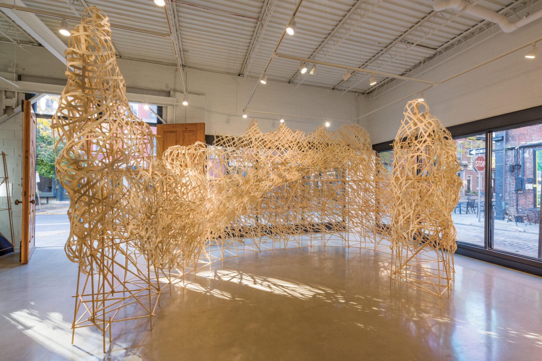 STEPHEN TALASNIK, Glacier, 2023. Pine stick infrastructure with bamboo ﬂat reed, 12 ft tall with a footprint of 500 sq ft (approx.)