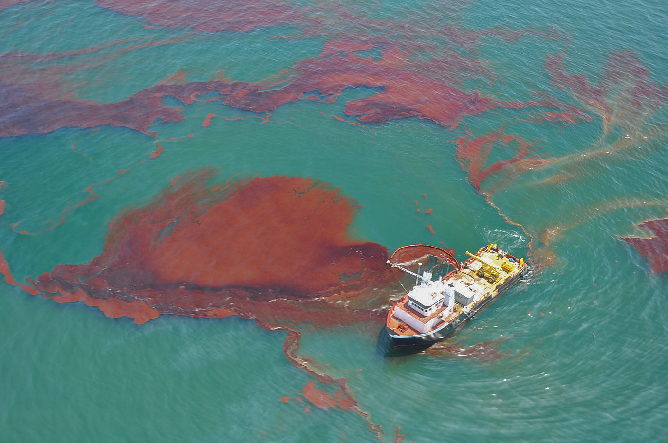 A skiff cleans up oil from the Deepwater Horizon oil spill in the Gulf of Mexico