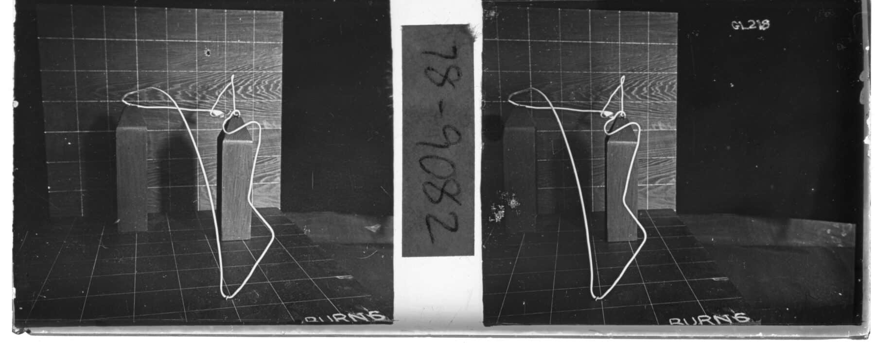 Frank and Lillian Gilbreth, Wire model sitting on gridded table in front of gridded background. On the gridded table is printed the name “Burns.”