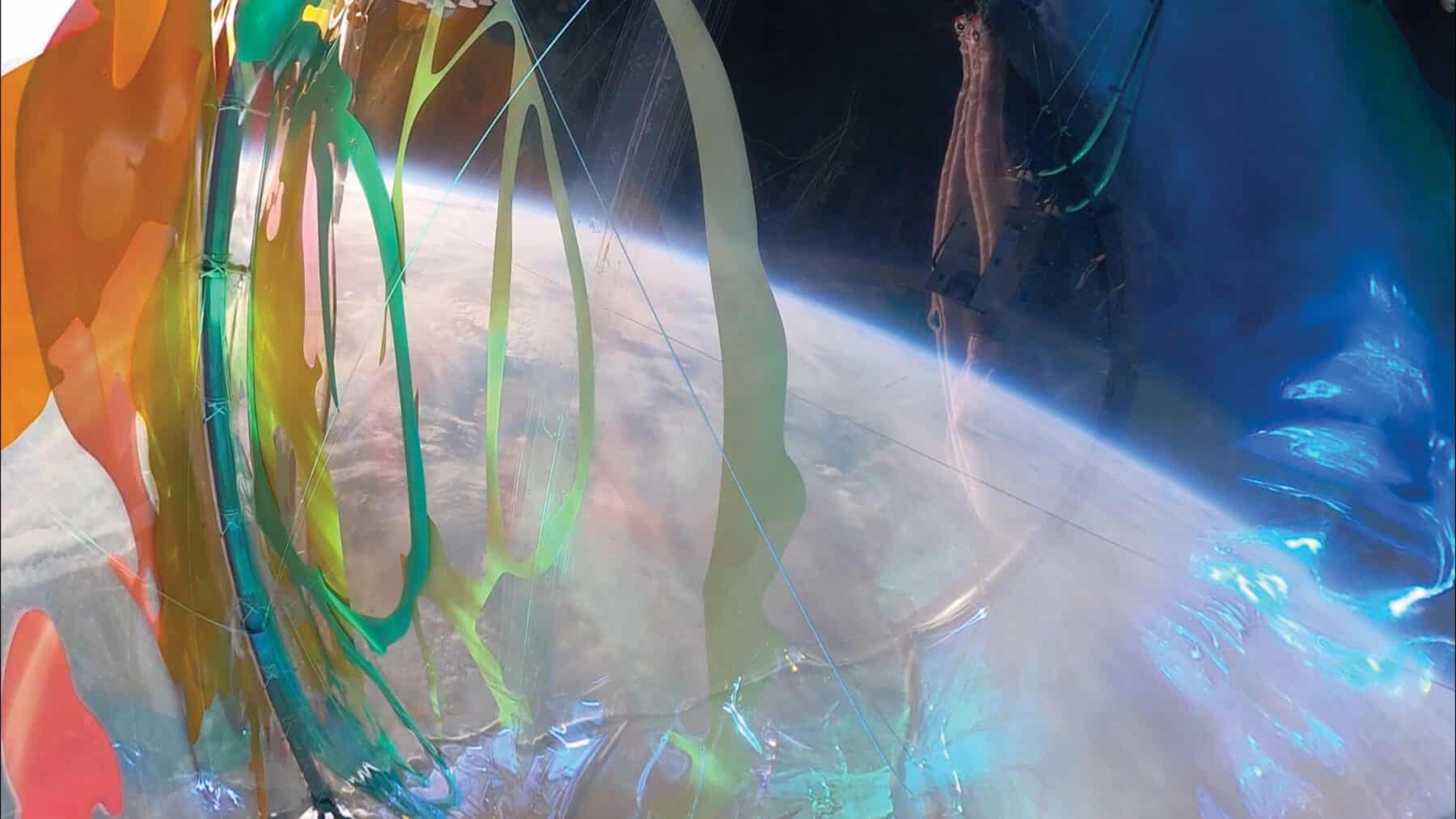 BEYOND EARTH (artist collective) with RICHELLE ELLIS, Living Light, 2021, steel frame, AI-generated forms on laser-cut vinyl, iridescent PVC, clear PVC, laser-cut foam floats, glow-in-the-dark tape, suspended by a 50-foot Stratollite balloon at 120,000 feet above Earth, dimensions variable. Credit: Space Perspective / Beyond Earth.